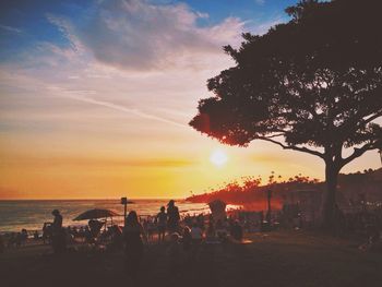 People on beach at sunset