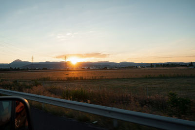 Scenic view of field against sky during sunset