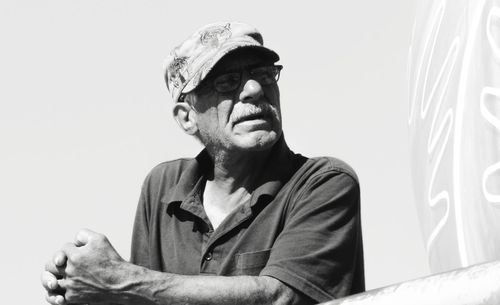 Portrait of man looking away against wall