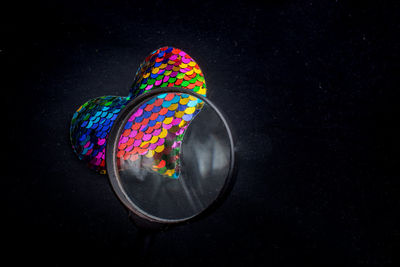 High angle view of multi colored light painting against black background