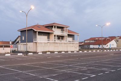 Surface level of road by building against sky