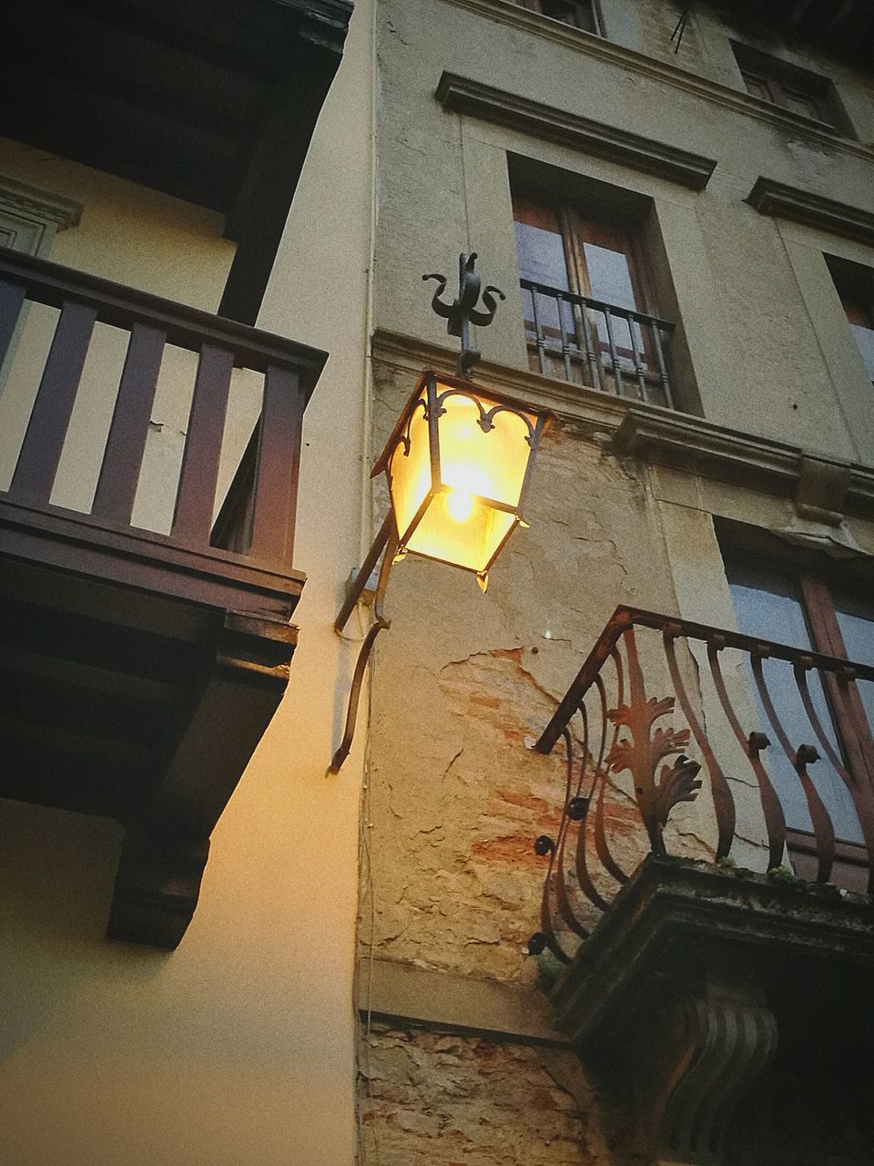 LOW ANGLE VIEW OF ILLUMINATED LIGHTING EQUIPMENT ON WALL