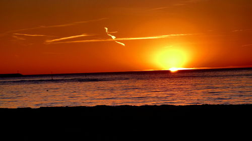 Scenic view of sea against orange sky