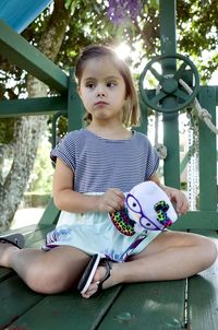 Portrait of cute girl sitting outdoors