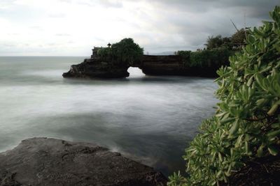 Scenic view of sea against cloudy sky