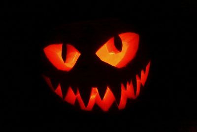 Close-up of illuminated pumpkin against black background