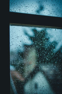 Raindrops on glass window in rainy season