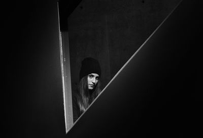 Portrait of woman standing against wall