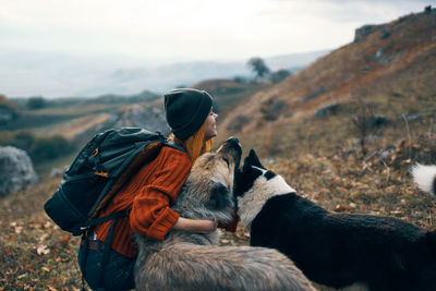 Rear view of man with dog on mountain