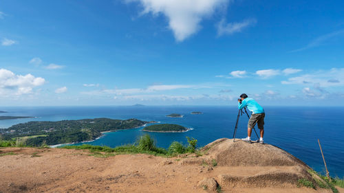 Man standing by sea against sky