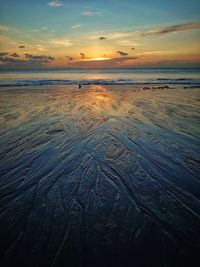 Scenic view of beach against sky during sunset