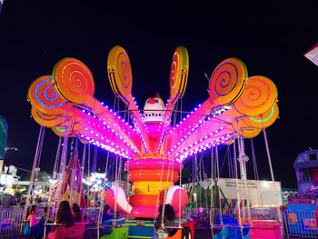 Illuminated carousel at night