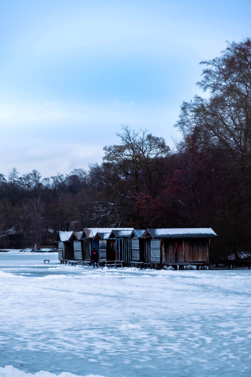 winter, snow, cold temperature, tree, nature, sky, architecture, plant, ice, built structure, freezing, frozen, reflection, building exterior, scenics - nature, building, environment, no people, day, beauty in nature, house, cloud, outdoors, landscape, white, water, land, blue, hut