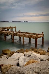 Pier over sea against sky