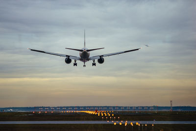 Low angle view of airplane flying against sky