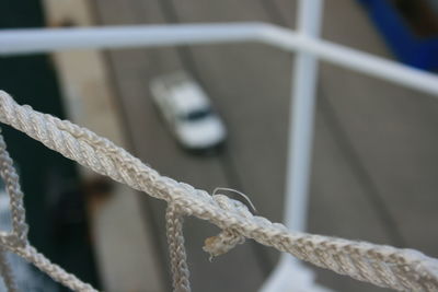 Close-up of rope tied to railing