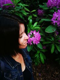 Close-up of woman with pink flowering plants