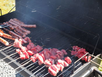 High angle view of meat on barbecue grill