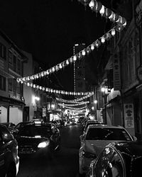 Cars parked in parking lot at night