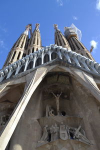 Low angle view of statues on building against sky