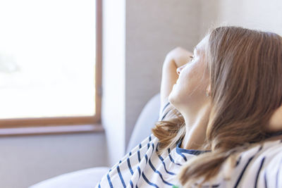 Side view of mother and daughter at home