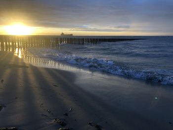 Scenic view of beach against sky during sunset