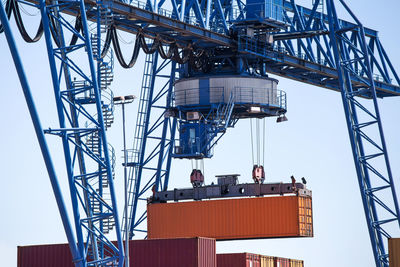 Low angle view of crane against sky