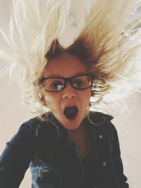 Low angle portrait of shocked girl with blond hair