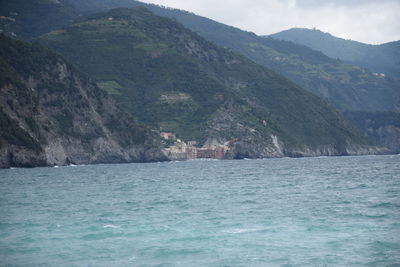 Scenic view of sea and mountains against sky