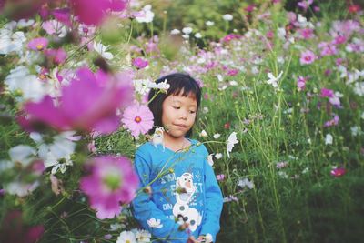 Cute girl standing flowers outdoors