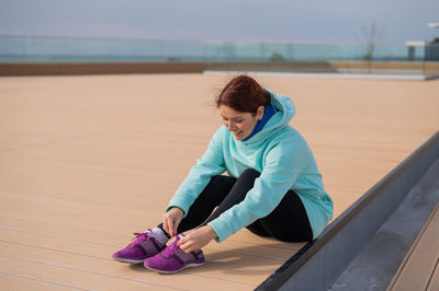 Portrait of young woman sitting on beach