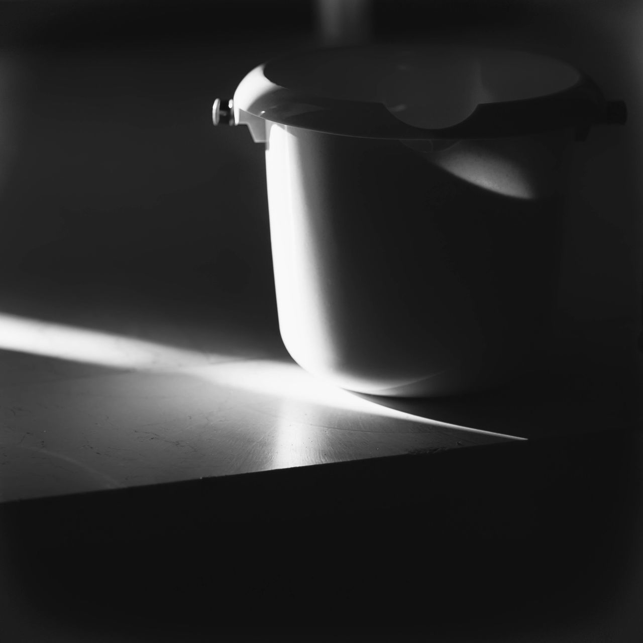 CLOSE-UP OF LIT CANDLES ON TABLE IN DARKROOM