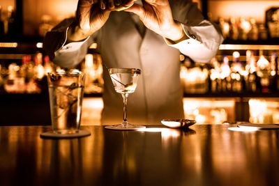 Bartender finishing a martini cocktail