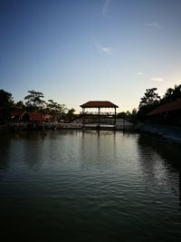 Silhouette built structure against sky at sunset