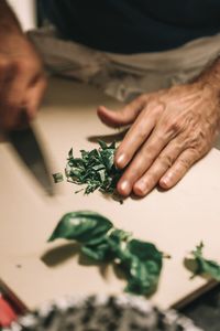 Midsection of man preparing food on table