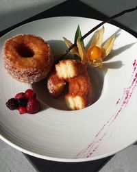 Close-up of donuts with berries served on plate