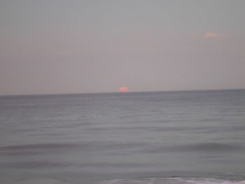 Scenic view of sea against clear sky during sunset