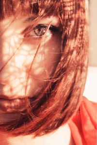 Close-up portrait of young woman at home