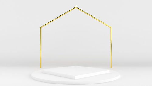 Close-up of white table against wall