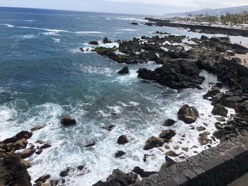 High angle view of rocks on sea shore