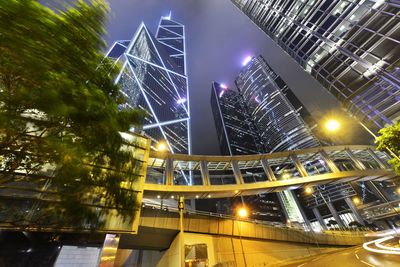 Low angle view of illuminated skyscrapers against sky at night
