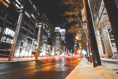 Illuminated city against sky at night