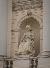 Low angle view of angel statue against temple