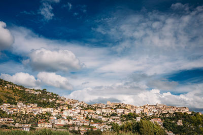 Buildings in town against sky