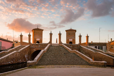 Exterior of historic building against sky during sunset