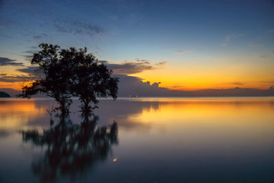 Scenic view of lake against romantic sky at sunset