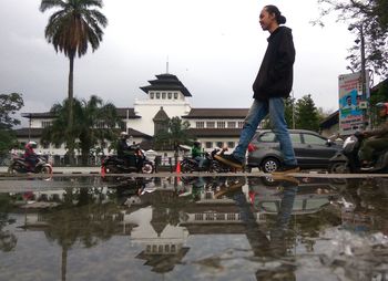 Reflection of man in puddle