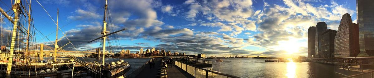 Cityscape against cloudy sky at sunset