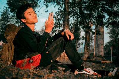 Young man looking at camera in forest