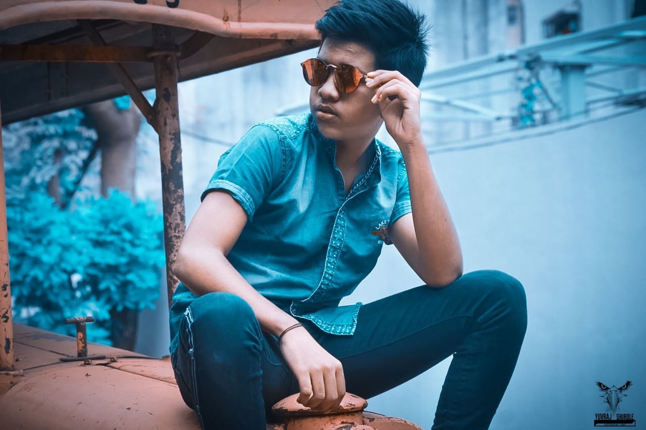 blue, adult, sitting, one person, photo shoot, young adult, person, fashion, lifestyles, relaxation, men, casual clothing, clothing, architecture, city, spring, technology, listening, nature, glasses, emotion, outdoors, women, leisure activity, teenager, sports, communication, looking, activity, footwear, human face